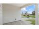 View of the back patio with gray siding and a glimpse of the community area at 802 Dorset Stream Dr, Fuquay Varina, NC 27526