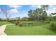 Community dog park with green grass, black fence, and a walking path at 802 Dorset Stream Dr, Fuquay Varina, NC 27526