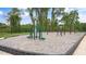 Outdoor fitness area with equipment, wood chip ground covering, and shade trees at 802 Dorset Stream Dr, Fuquay Varina, NC 27526