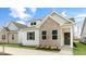 Charming home features a brick facade, white siding, and well-maintained landscaping at 802 Dorset Stream Dr, Fuquay Varina, NC 27526
