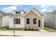 Charming home features a brick facade, white siding, and well-maintained landscaping at 802 Dorset Stream Dr, Fuquay Varina, NC 27526