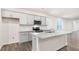 Kitchen with stainless steel appliances, white cabinets, and a granite island at 802 Dorset Stream Dr, Fuquay Varina, NC 27526