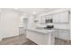 Kitchen with stainless steel appliances, white cabinets, and a granite island at 802 Dorset Stream Dr, Fuquay Varina, NC 27526
