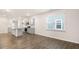Open living area with wood-look floors, light walls, and kitchen with a granite island at 802 Dorset Stream Dr, Fuquay Varina, NC 27526