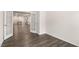 Open living area with wood-look floors, light walls, and white french doors at 802 Dorset Stream Dr, Fuquay Varina, NC 27526