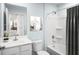 Bathroom featuring a pristine white tub and vanity complemented by modern fixtures at 331 Tormore Dr, Sanford, NC 27330