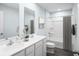 Well-lit bathroom with double sink vanity, sleek white cabinets, and modern fixtures at 331 Tormore Dr, Sanford, NC 27330