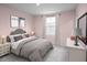 Cozy bedroom with pink walls, stylish decor, comfortable bedding, and soft, natural light at 331 Tormore Dr, Sanford, NC 27330