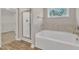 Bathroom featuring a garden tub and walk-in closet at 445 E Clydes Point Way, Wendell, NC 27591