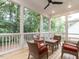 Relaxing screened porch with wicker furniture and wooded views at 119 Sanderway Dr, Chapel Hill, NC 27516