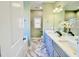Bright bathroom featuring double vanity, marble floors, and a bathtub with a window at 144 Emerson Fields Dr, Pikeville, NC 27863