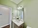 Stylish half-bath with a gray vanity, quartz countertop, modern mirror, and fixtures at 144 Emerson Fields Dr, Pikeville, NC 27863