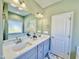 Bright bathroom featuring a dual sink vanity with white marble countertop and neutral paint at 144 Emerson Fields Dr, Pikeville, NC 27863