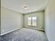 Bright bedroom featuring neutral carpet, natural light from a window, and light-colored walls at 144 Emerson Fields Dr, Pikeville, NC 27863