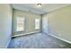 Bedroom featuring neutral carpet, two windows offering natural light, and light-colored walls at 144 Emerson Fields Dr, Pikeville, NC 27863
