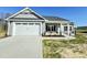 Inviting one-story home with a two-car garage, well-manicured lawn, and a charming front porch at 144 Emerson Fields Dr, Pikeville, NC 27863