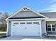 Two car garage door with decorative trim and stone accents at 144 Emerson Fields Dr, Pikeville, NC 27863
