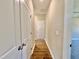 Hallway with wood flooring, white trim, and a closet at 144 Emerson Fields Dr, Pikeville, NC 27863