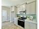 Modern kitchen featuring stainless steel appliances, light gray cabinets, and stylish backsplash at 144 Emerson Fields Dr, Pikeville, NC 27863