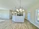 Open concept kitchen with modern light fixtures, stainless appliances, and eat-in bar top at 144 Emerson Fields Dr, Pikeville, NC 27863