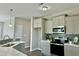 Bright kitchen features gray cabinets, stainless steel appliances, and counter-height bar at 144 Emerson Fields Dr, Pikeville, NC 27863