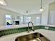 Kitchen sink featuring a counter-height bar overlooking the living room and fireplace at 144 Emerson Fields Dr, Pikeville, NC 27863