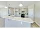 Bright kitchen features gray cabinets, stainless steel appliances, and counter-height bar at 144 Emerson Fields Dr, Pikeville, NC 27863