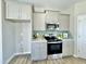 Kitchen featuring modern appliances, stylish backsplash, and gray cabinets at 144 Emerson Fields Dr, Pikeville, NC 27863