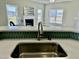 Kitchen sink featuring a counter-height bar overlooking the living room and fireplace at 144 Emerson Fields Dr, Pikeville, NC 27863
