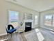 Cozy living room with fireplace, accent chair, and bright windows at 144 Emerson Fields Dr, Pikeville, NC 27863