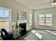 Bright living room featuring a fireplace, neutral walls, and hardwood floors covered by decorative area rug at 144 Emerson Fields Dr, Pikeville, NC 27863