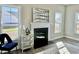 Bright living room featuring a fireplace, neutral walls, and hardwood floors covered by decorative area rug at 144 Emerson Fields Dr, Pikeville, NC 27863