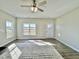 Bright living room featuring neutral walls, hardwood floors covered by an area rug, and a rear entry door at 144 Emerson Fields Dr, Pikeville, NC 27863