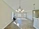 Bright living room with wood floors, a chandelier, a fireplace, and ample natural light at 144 Emerson Fields Dr, Pikeville, NC 27863