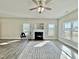 Bright living room featuring a fireplace, neutral walls, and hardwood floors covered by decorative area rug at 144 Emerson Fields Dr, Pikeville, NC 27863