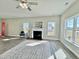 Bright living room featuring a fireplace, neutral walls, and hardwood floors covered by decorative area rug at 144 Emerson Fields Dr, Pikeville, NC 27863