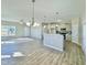 Open-concept living and kitchen area with a breakfast bar, stainless steel appliances, and hardwood flooring at 144 Emerson Fields Dr, Pikeville, NC 27863
