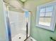 Bathroom shower with glass doors and window at 144 Emerson Fields Dr, Pikeville, NC 27863