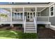Spacious covered back porch with ceiling fans and access to the backyard at 210 Colvard Farms Rd, Durham, NC 27713