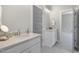 A bright bathroom features a double vanity with granite countertops and white cabinets and neutral grey paint at 210 Colvard Farms Rd, Durham, NC 27713