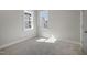 Bright bedroom with gray walls, white trim, two windows, and neutral carpet at 210 Colvard Farms Rd, Durham, NC 27713