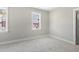 Bedroom featuring neutral carpet, white trim, neutral gray paint, and a window with natural light at 210 Colvard Farms Rd, Durham, NC 27713