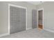 Neutral bedroom with gray walls, gray double doors, and an open doorway at 210 Colvard Farms Rd, Durham, NC 27713