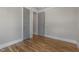 Neutral bedroom with hardwood flooring, gray walls, white trim, and 2 paneled doors at 210 Colvard Farms Rd, Durham, NC 27713