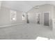 Large bonus room with neutral carpet, gray paint, white trim, two windows, and an attached bathroom at 210 Colvard Farms Rd, Durham, NC 27713