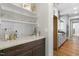 Butler pantry featuring stone countertops, floating shelves and glass storage at 210 Colvard Farms Rd, Durham, NC 27713