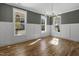 Bright dining room with hardwood floors, wainscoting, large windows, and decorative chandelier at 210 Colvard Farms Rd, Durham, NC 27713