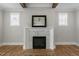 Cozy fireplace with a marble surround and a decorative mirror in the living room at 210 Colvard Farms Rd, Durham, NC 27713
