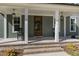 Inviting front porch with rocking chairs and stylish light fixtures at 210 Colvard Farms Rd, Durham, NC 27713