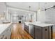Modern kitchen with a large island, stainless steel appliances, and hardwood floors at 210 Colvard Farms Rd, Durham, NC 27713